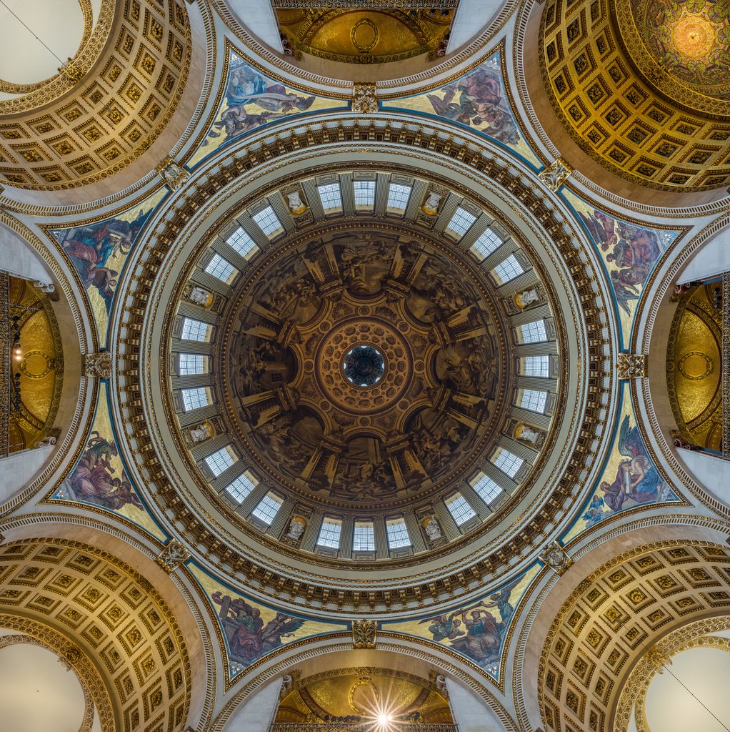 A symmetrical upward view centres a painted circular dome inside rings of windows, mosaics, pendentives and richly coffered crossing arches.