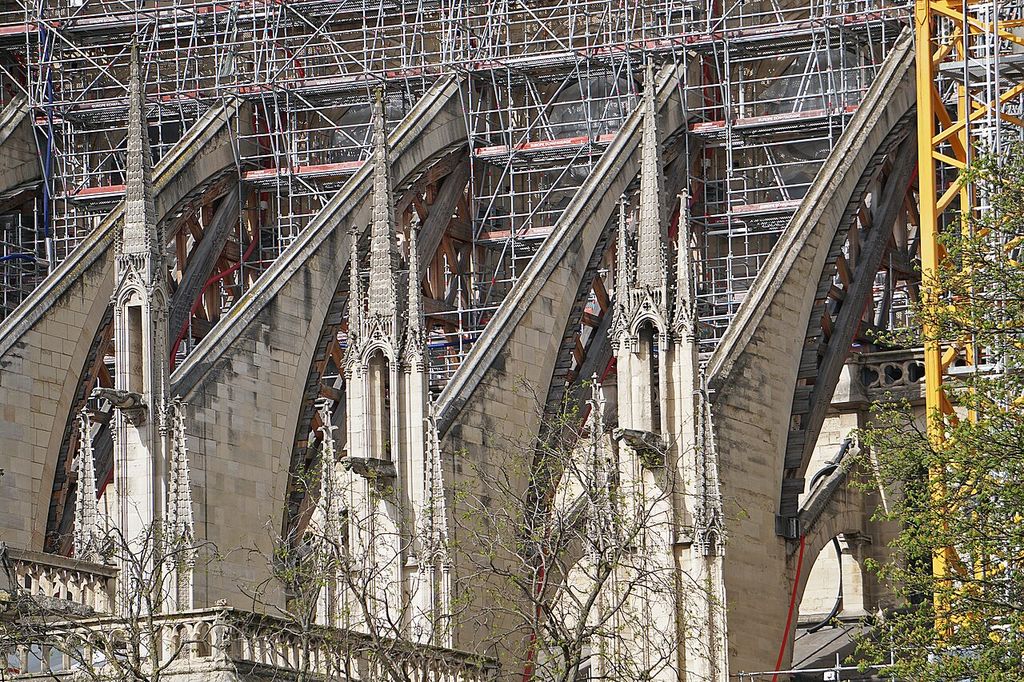 Wooden frames support stone flying arches amid restoration work at a cathedral.