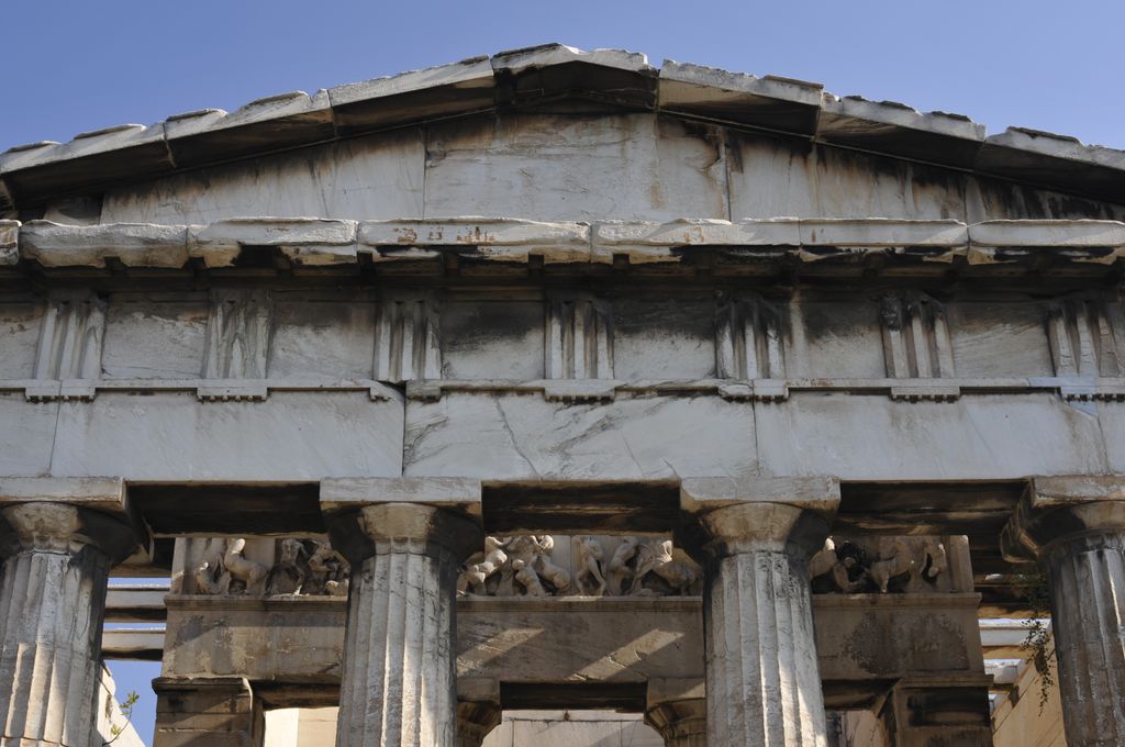 Fluted upper shafts and broad capitals support a plain architrave and a frieze of grooved triglyphs alternating with square metopes.