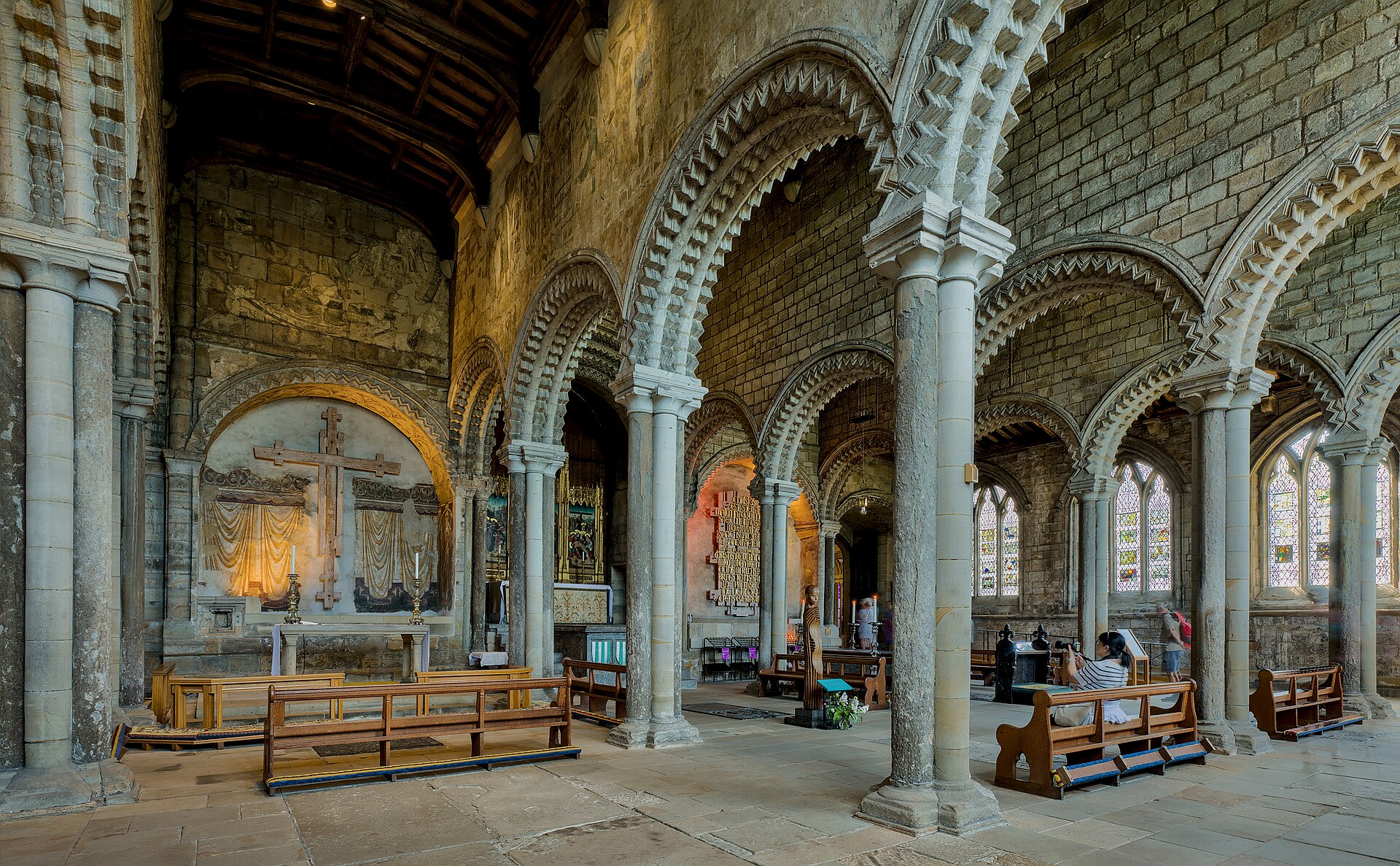 Durham Cathedral's Galilee Chapel with low timber ceiling, slender clustered supports, intersecting round arcades, chevron carving and traces of colour.