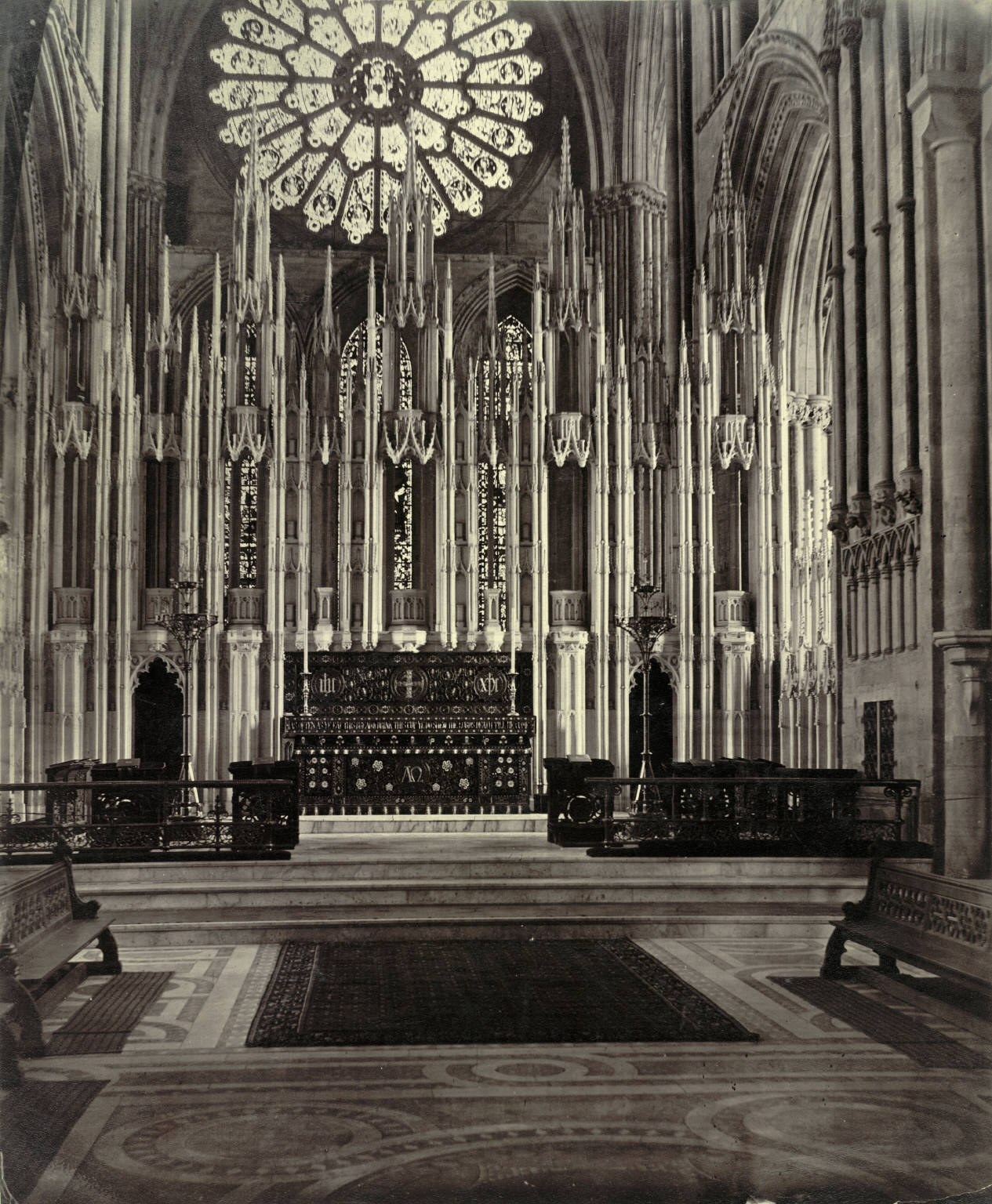 Historic black-and-white view of Durham Cathedral's high altar and tall canopied Neville Screen beneath the eastern vault.