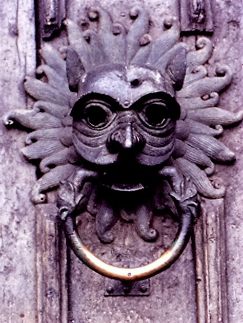 Animal-headed sanctuary ring with projecting eyes, mane and a brass-coloured ring on Durham Cathedral's north door.
