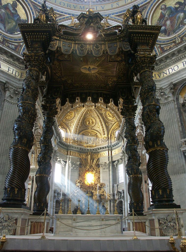 Four huge twisted bronze columns support an ornate canopy over an altar, with a bright gilded sculptural ensemble aligned in the distant apse.