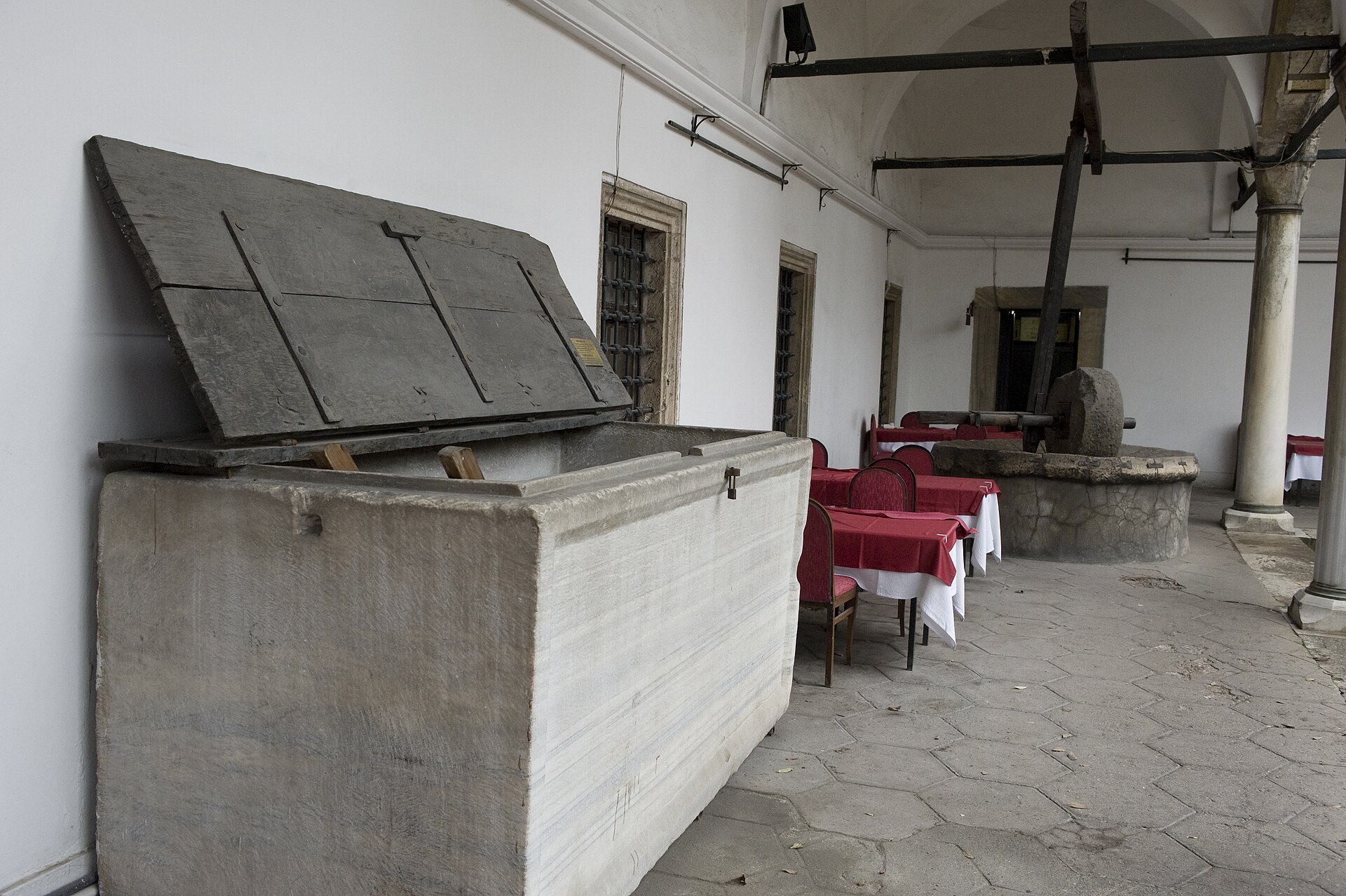 Interior of the Süleymaniye imaret with stone service structure and later restaurant tables, photographed in 2008.