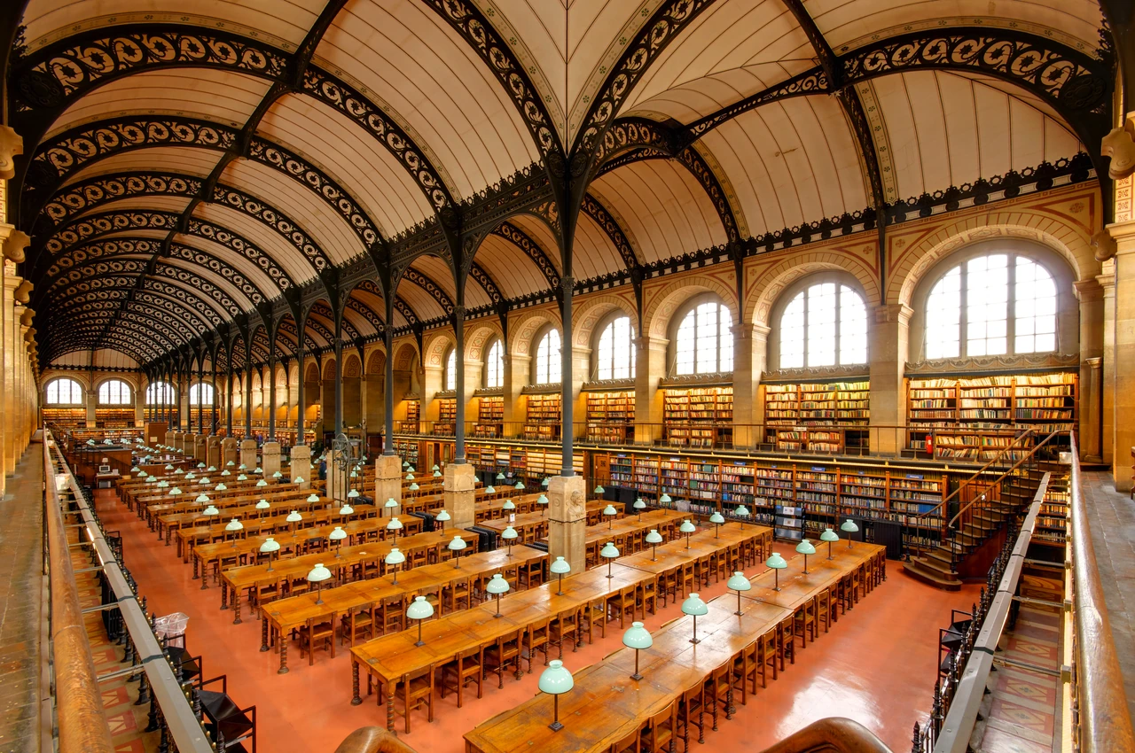 A line of slender columns and pierced dark arches divides Sainte-Geneviève’s two reading aisles beneath pale vaults and high windows.
