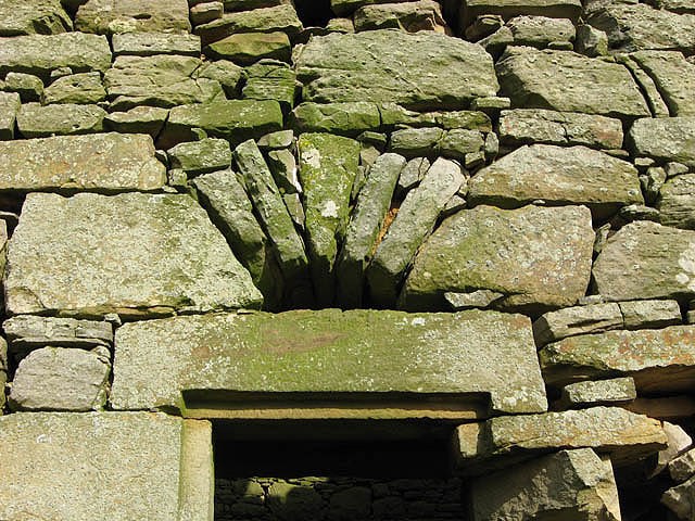 Mervinslaw doorway with stone jambs and a broad flat lintel below radiating stones of a relieving arch.