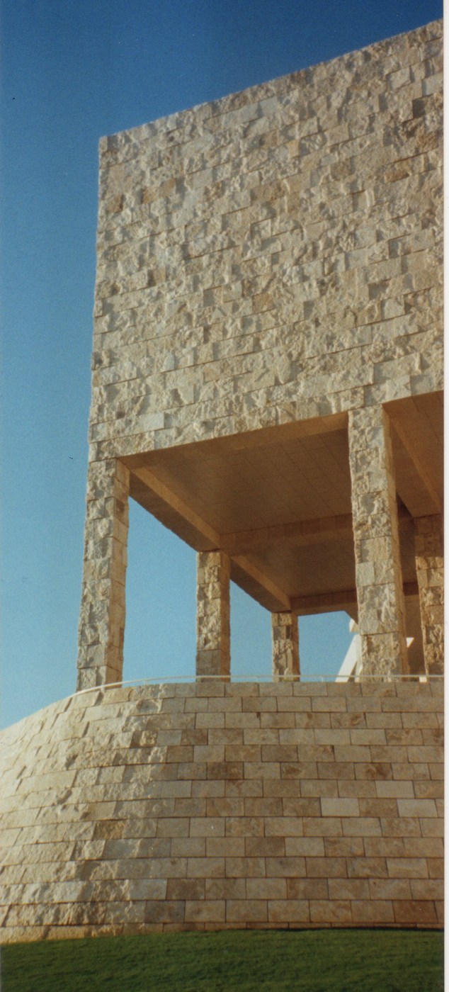 Getty Center travertine wall and recessed building edges against a blue sky.