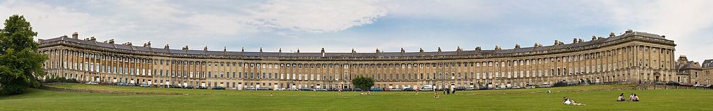 A long curved stone terrace with a continuous giant order faces a broad lawn.