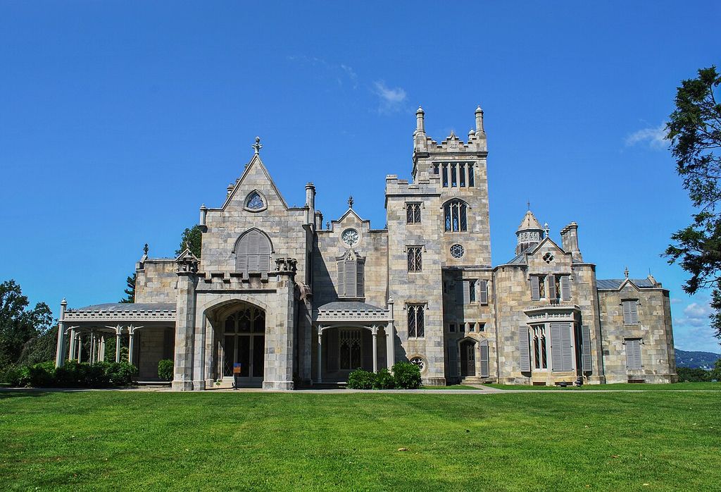 A stone villa combines a tall square tower, unequal gables, pointed openings and open porches.