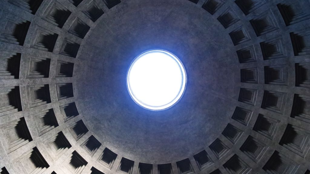 Concentric rows of recessed coffers around the bright circular oculus of the Pantheon dome.