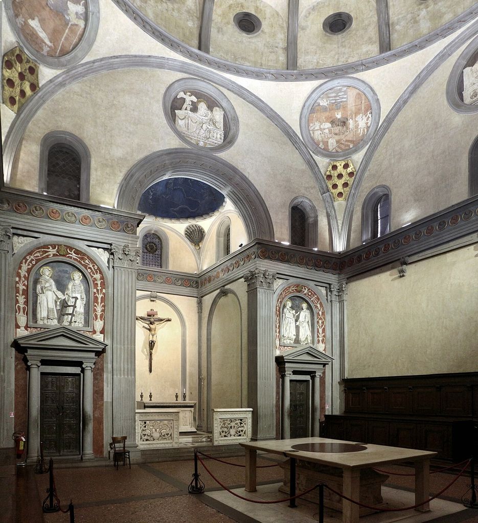 Grey arches, pilasters and entablatures outline pale walls, pendentives and a smaller altar bay in the Old Sacristy.