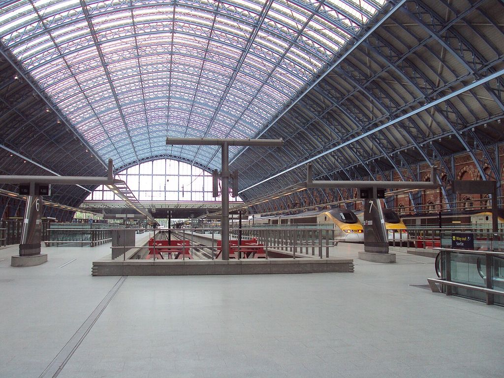 The great arched train shed at St Pancras, with glazed roof and platforms.