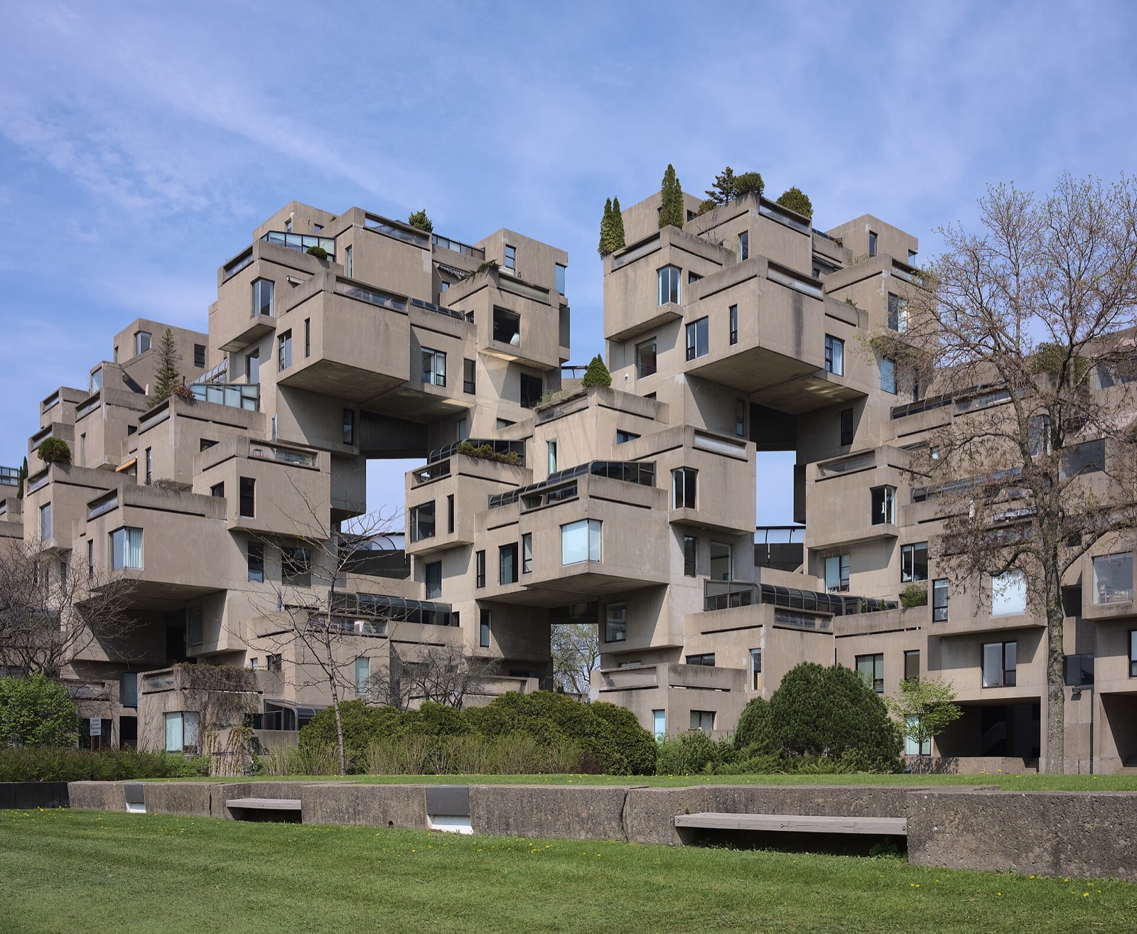 Ground-level Habitat 67 view of stepped concrete modules, terraces, openings and gardens in Montreal.