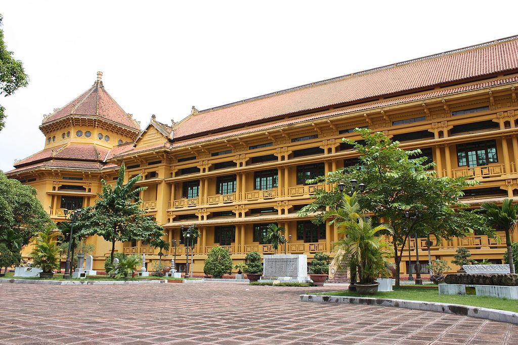 An octagonal entrance volume with a layered roof joins a long museum range with deep eaves and sheltered galleries.