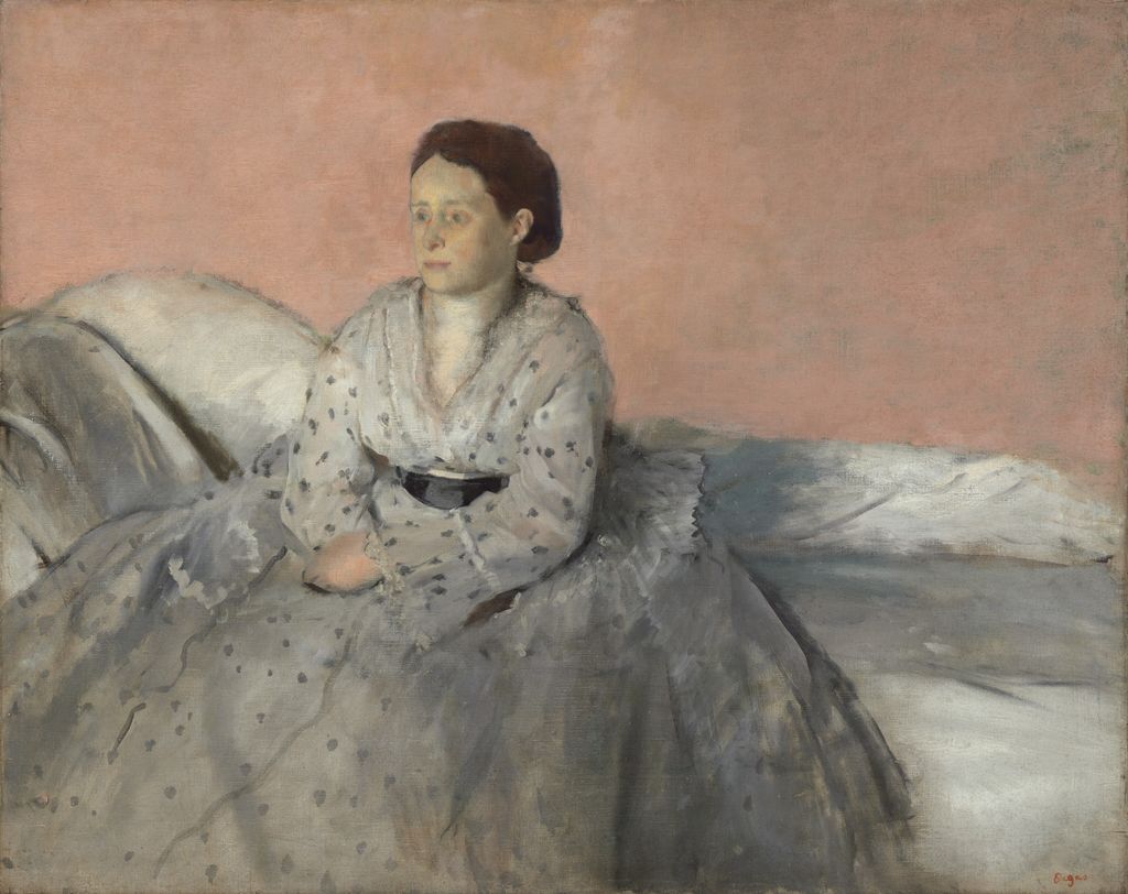 Estelle de Gas seated alone in a pale dotted dress