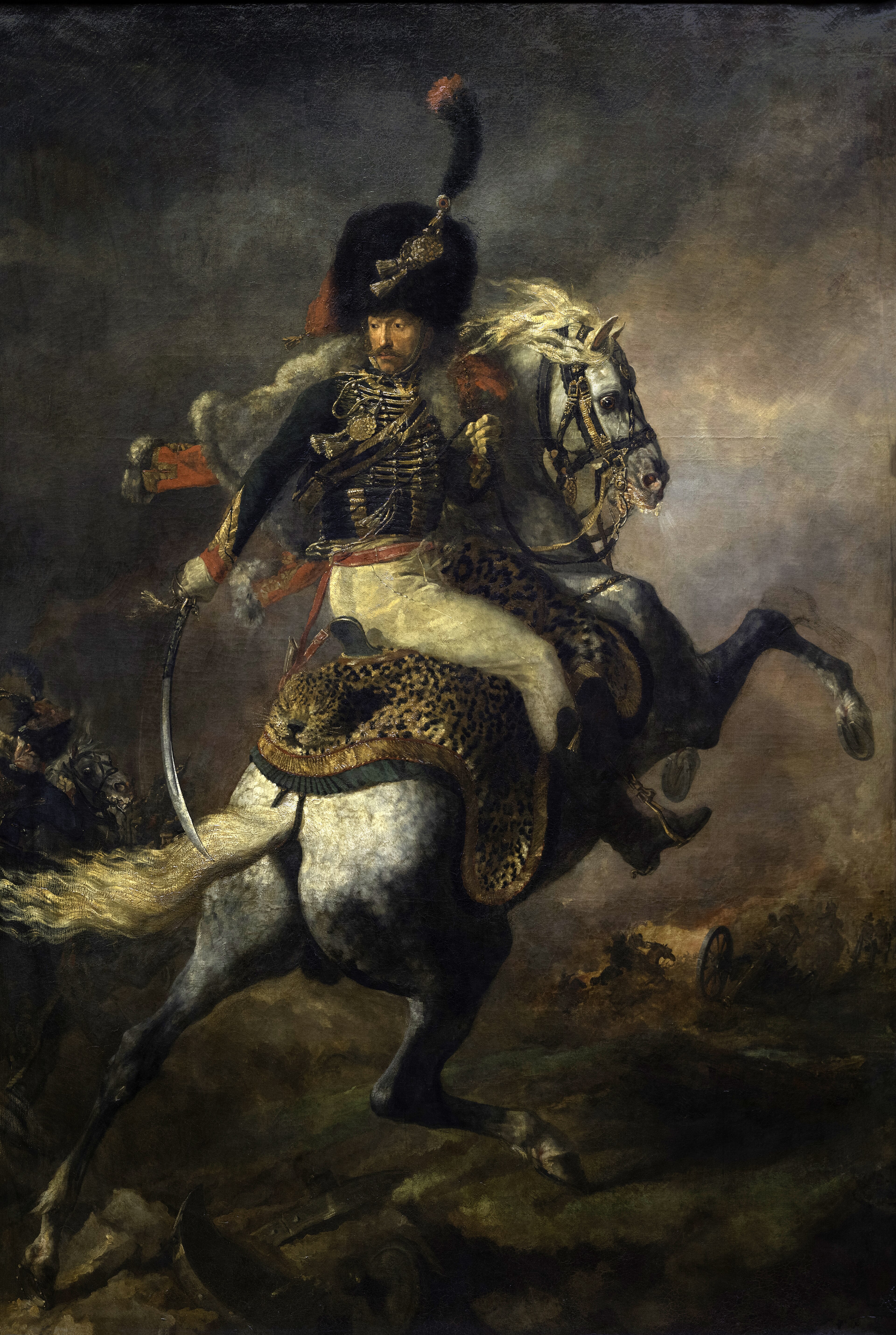 A mounted imperial officer turns in the saddle as his rearing horse charges through smoke in Géricault's painting.
