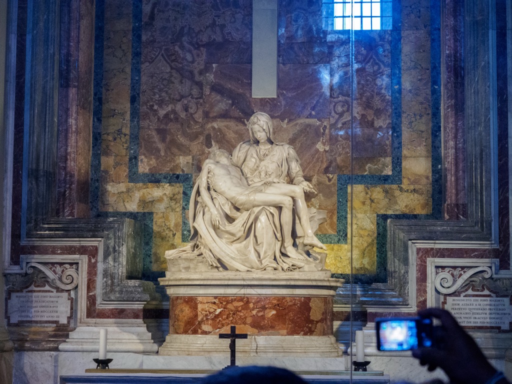 Michelangelo's Pieta forms a broad seated base that narrows towards the head of the Virgin