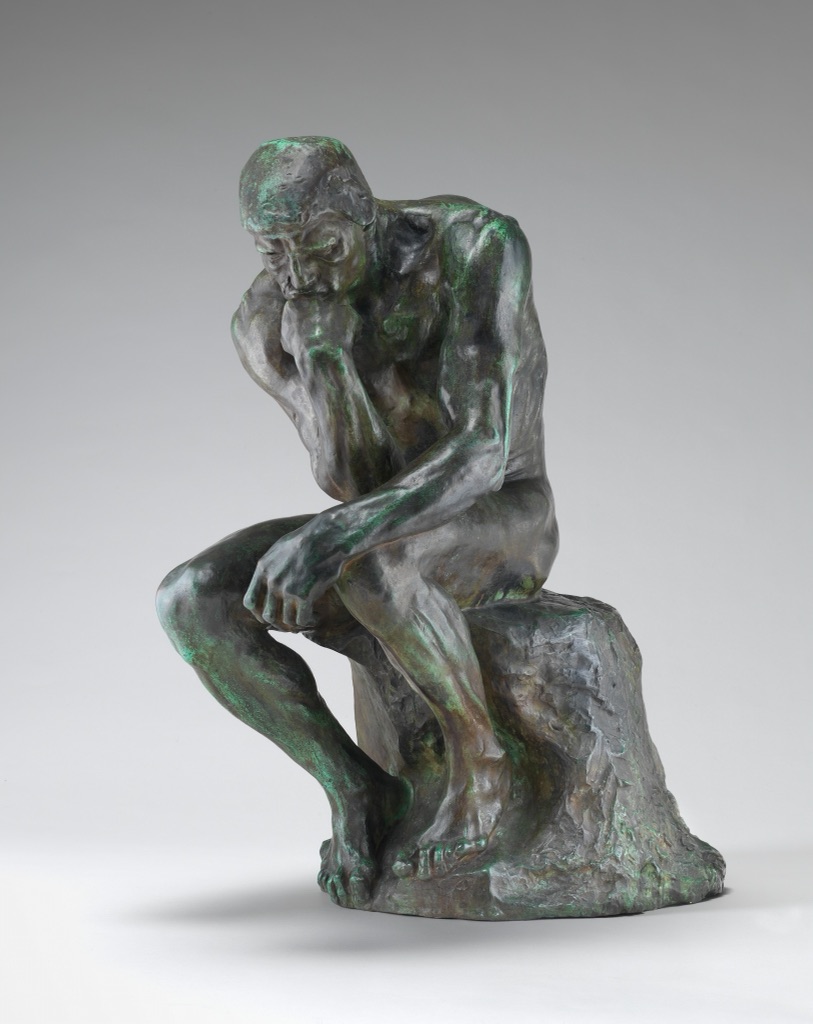 Rodin's bronze Thinker bends forward with one hand under his chin and his limbs gathered into a compact twisting pose.