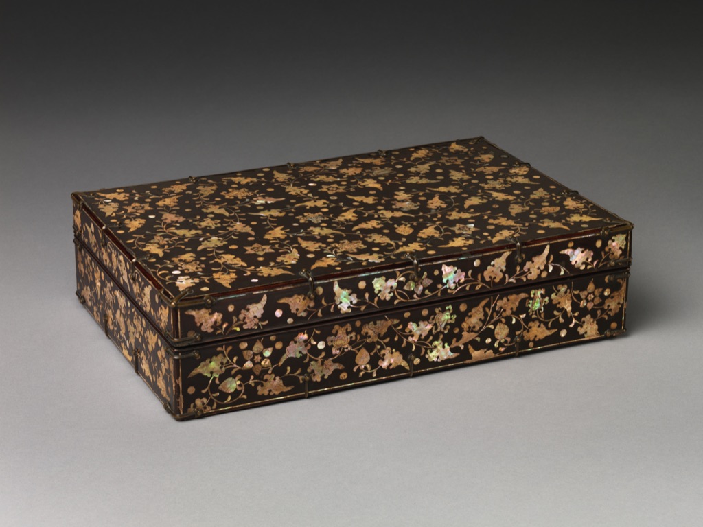 The Korean stationery box has a glossy dark lacquer surface inlaid with mother-of-pearl peony scrolls and edged with brass fittings.