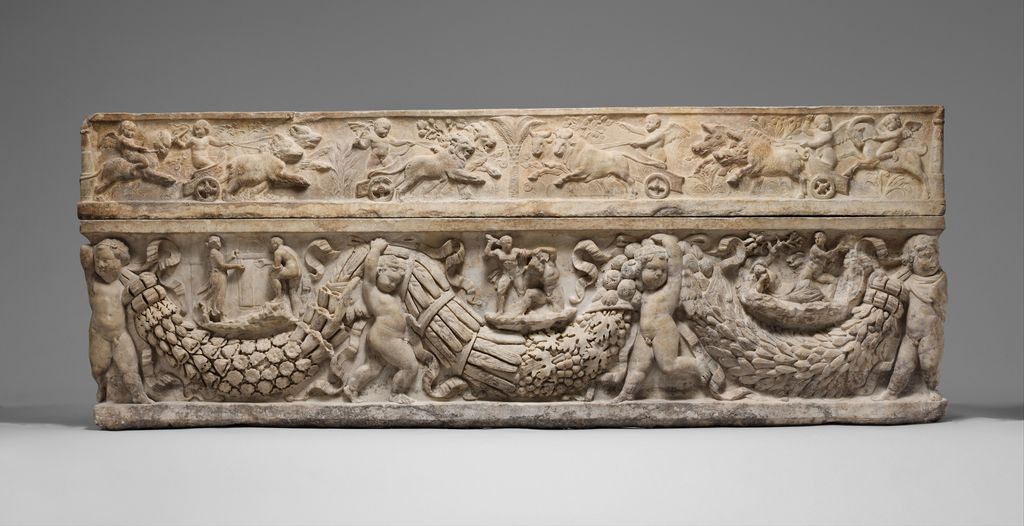 A Roman marble sarcophagus bears hanging garlands and framed relief scenes from the myth of Theseus and Ariadne.
