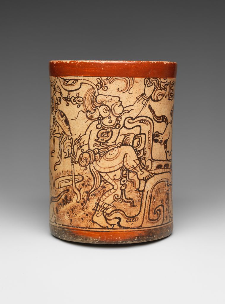 A cylindrical Maya vessel shows differently posed profile figures, elaborate headdresses and glyphic forms painted around its pale surface.