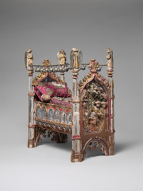 Elaborate miniature crib combining carved wood, gilded silver, parchment, embroidery, pearls and enamel.