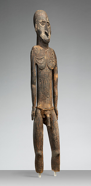 Sawos wood ancestor figure with painted surface, fibre attachments and ferrous metal.